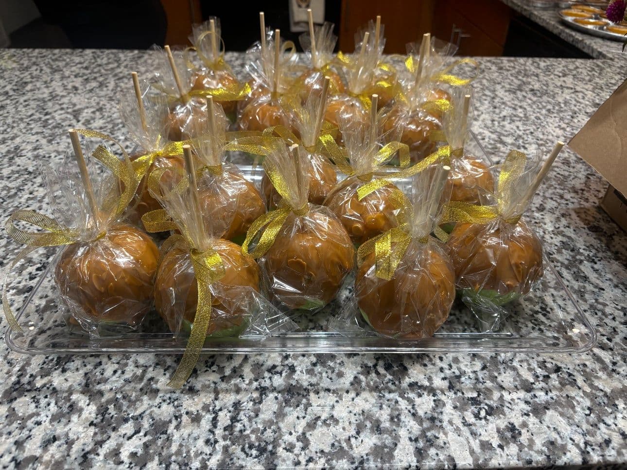 Hand-wrapped caramel apples with gold ribbon for a fall party in Northwest Ohio