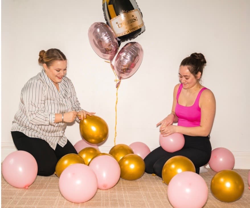Lexi and Harmony, founders of MollyBoo Events, working on balloons