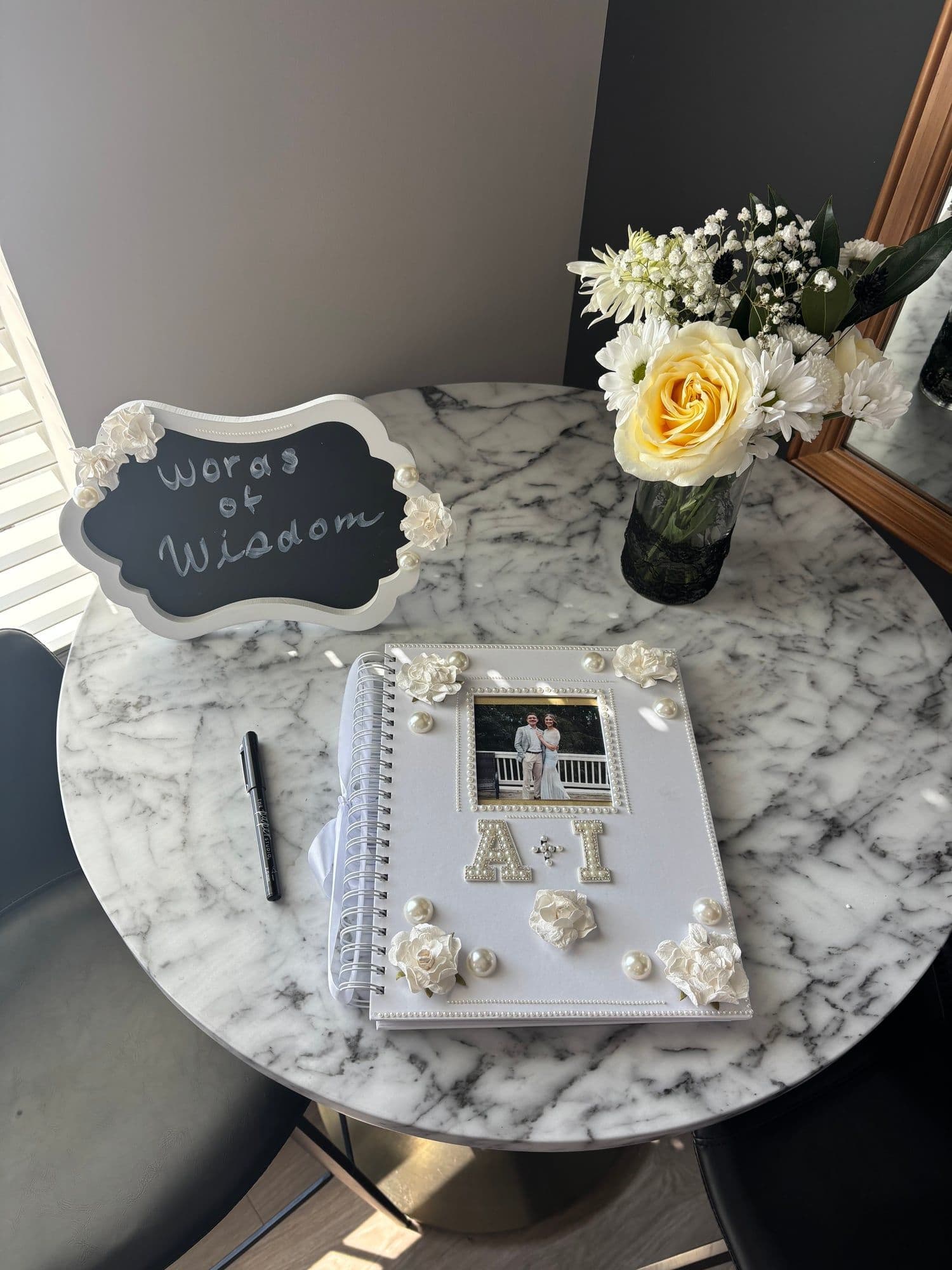 Pearl-embellished wedding guestbook and "Words of Wisdom" sign styled in Toledo, Ohio
